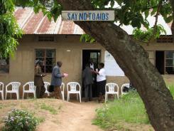A clinic with "say no to AIDS" on a sign on a tree in front of it